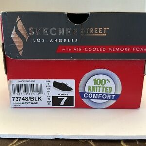 New in box ! Women’s size 7 Skechers black slip on tennis shoe